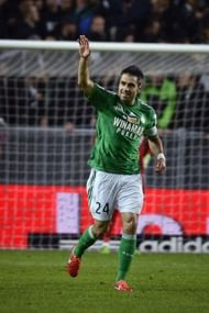 Saint-Etienne's midfielder Loic Perrin waves after scoring a goal on May 18, 2013 in Saint-Etienne, central France